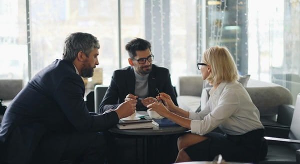 A woman composing a sales proposal amidst resources and sales proposal examples